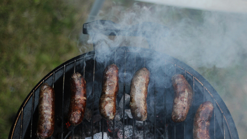 Sausages sizzling on a barbeque.