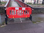 A red barrier blocking the entrance to Goodland Gardens footbridge in Taunton.