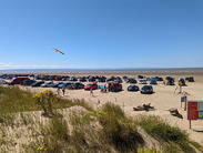 Brean beach, cars parked on the beach with the sea in the distance.