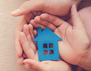 Social graphic featuring a child's and adult's hands cupping a cardboard cutout of a house, captioned: 'Have your say'.