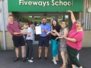 Pupils and teachers posing outside the entrance of Fiveways School.