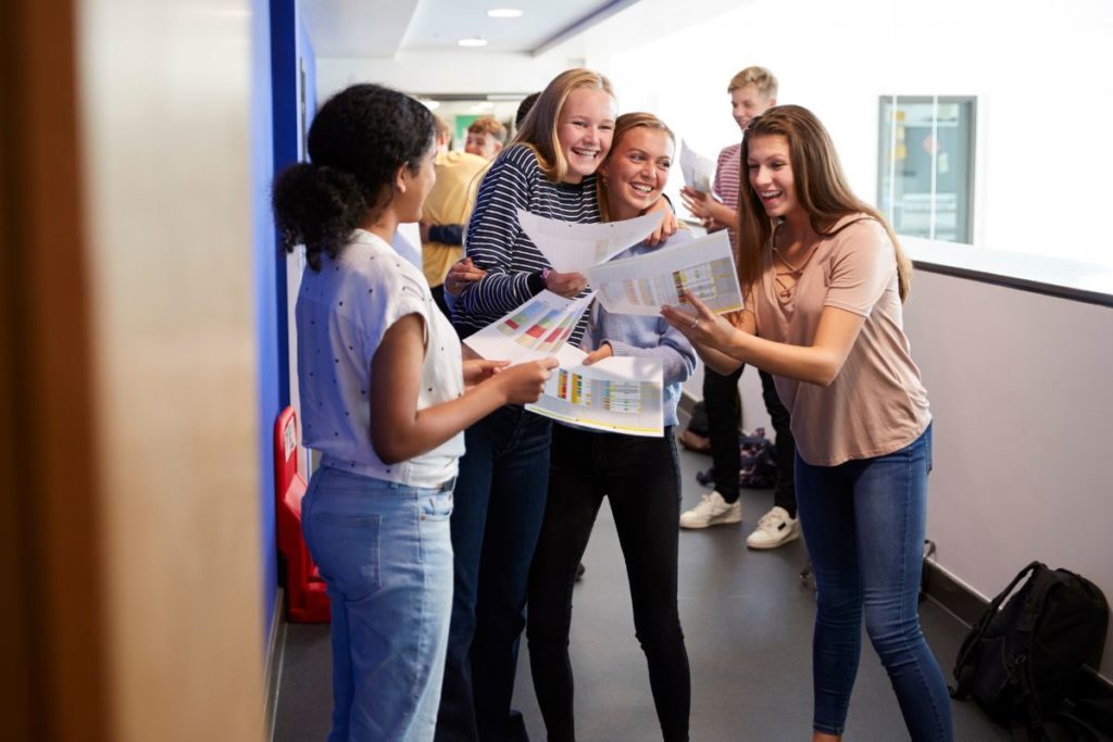 Students smiling looking at exam results