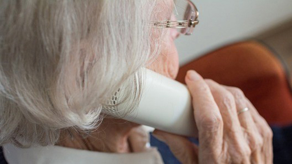 An elderly lady on the phone.