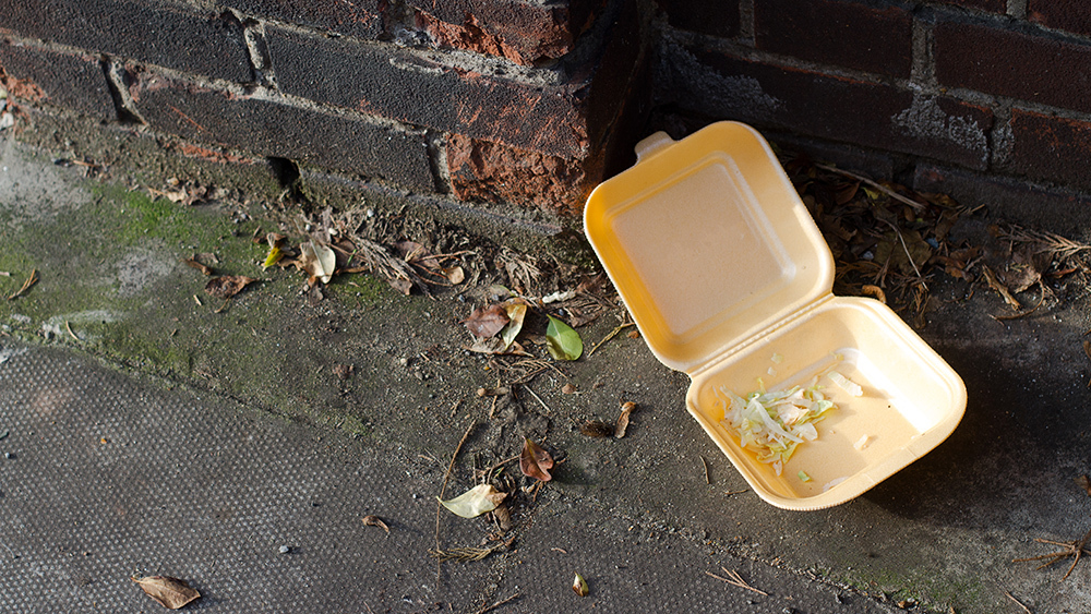Take away fast food box on pavement.