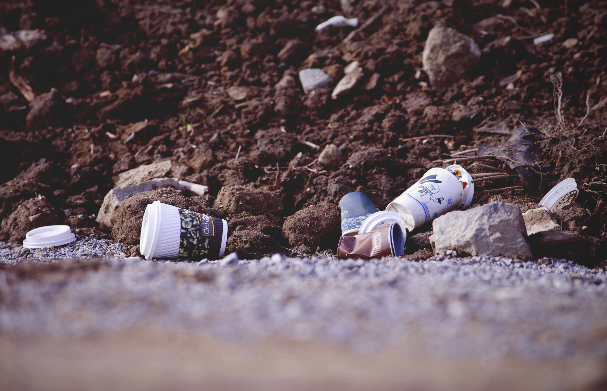 discarded single use cups on a beach