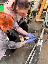 Two people repairing a bicycle