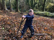 A young boy planting a tree