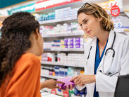 A pharmacist advising a customer.