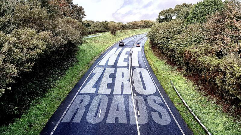 A dual carriage way flanked with grass and tree-lined embankments, captioned: 'Net Zero Roads'.