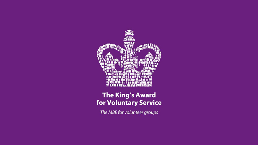 Kings Awards for Voluntary Service logo consisting of a white crown on a purple background.