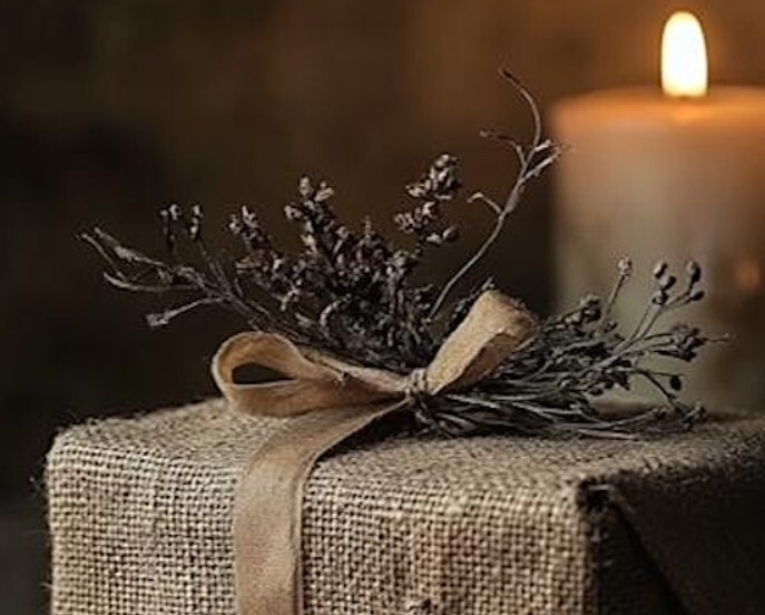 a gift wrapped in sacking with foliage decor