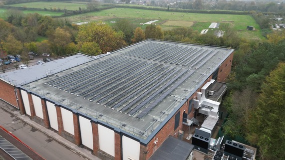 Aerial view of Wellington sports centre with solar panels on roof and air source heat pumps at side of building