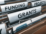 Folder tabs in a filing cabinet marked 'Funding, Projects and Grants'.