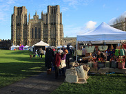 Wells christmas market with stalls in font the Cathedral.