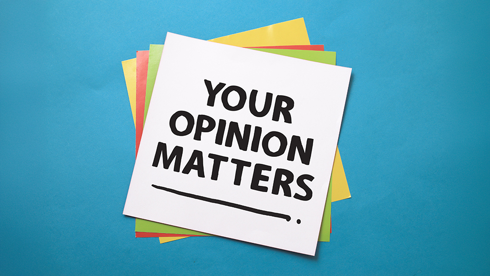 A stack of multi-coloured post-it notes on a blue background. The top note is captioned: 'Your opinion matters'.