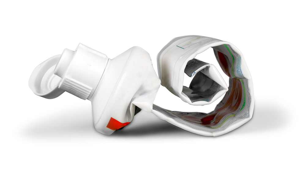 A rolled-up, used toothpaste tube.