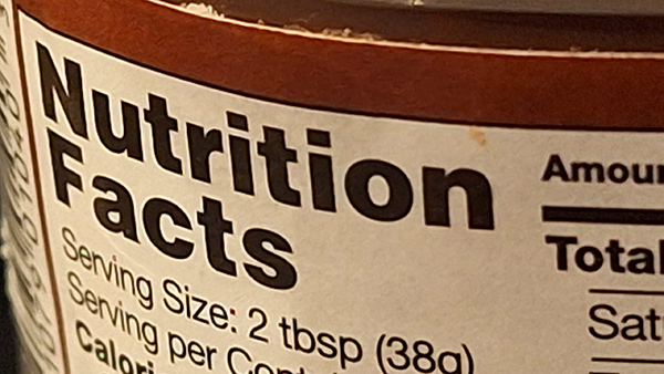 Close-up of a nutritional facts label on the side of a jar.
