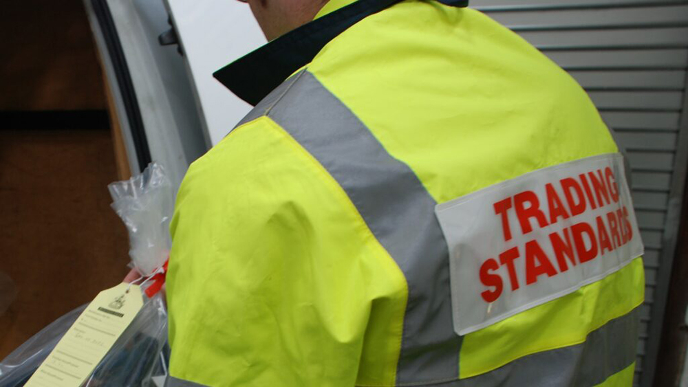 A Trading Standards Officer confiscating goods from a loot van.
