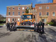 Pupils and staff from Brymore Academy posing with the newly named gritter, ‘Gritty Gritty Bang Bang’ and driver.