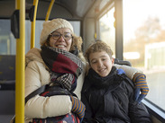 A woman and her child travelling on a public bus.