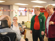 Four people chatting in a community setting.