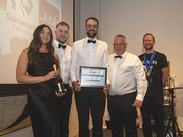 Group photo of the successful Firepool team holding their certificate and bottle of champagne at the CIHT South West awards ceremony.