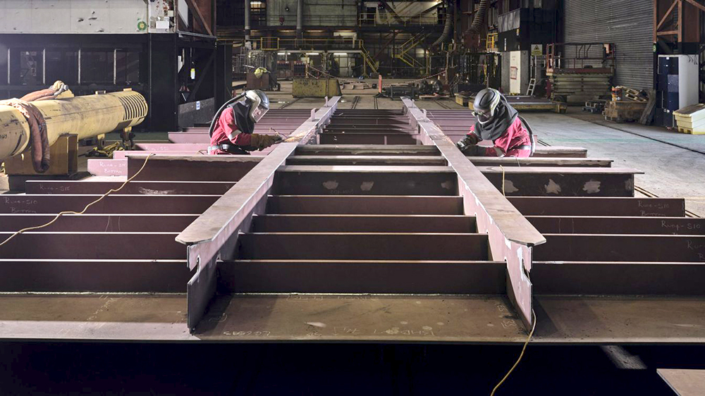 Workers welding structural steel beams at Harland Wolff shipbuilding yard, Appledore.