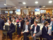 Delegates at a former Great South West Annual Conference seated at round tables in a large room, engaging in discussion and networking.
