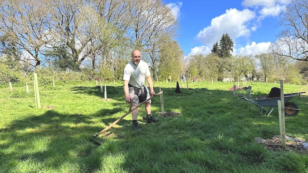 A man scything long grass at Linden Meadow, Wellington.