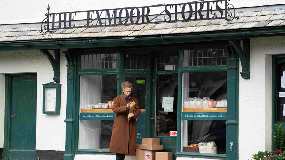 A still from the film Unmoored showing a woman outside The Exmoor Stores.