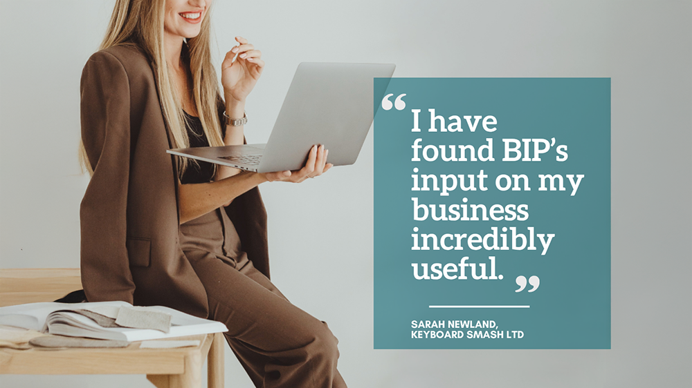 Woman in brown suit holding a laptop, with a quote: “BIP's input on my business was incredibly useful” – Sarah Newland, Keyboard Smash Ltd.