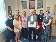 Public Health and libraries staff join Jim Binning at the opening of the Finnis Room at Yeovil Library.