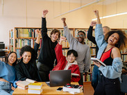 Stock image of a group of students giving high fives by Yan Krukau from Pexels.