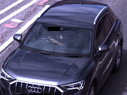 Image of a car driver using a mobile phone.