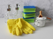 Stock image by Monfocus from Pixabay showing gloves, sponges, soap dispensers, and a jar of powder with scoop on a white surface.
