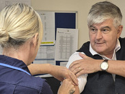 Cllr Oakes receiving a flu vaccine.