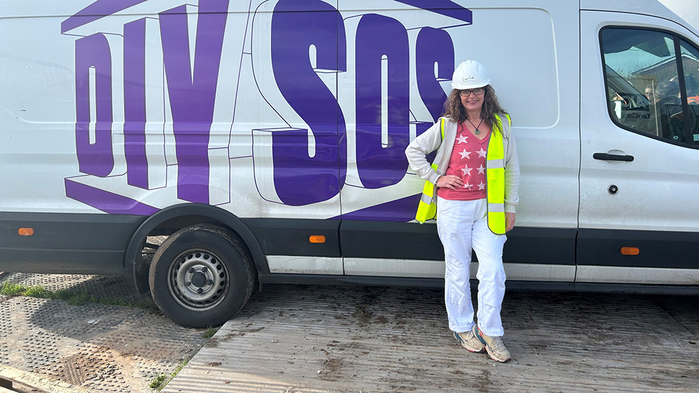 Somerset Council Responsive Repairs team member, Carrie Robinson, posing in front of the BBC's DIY SOS team van.