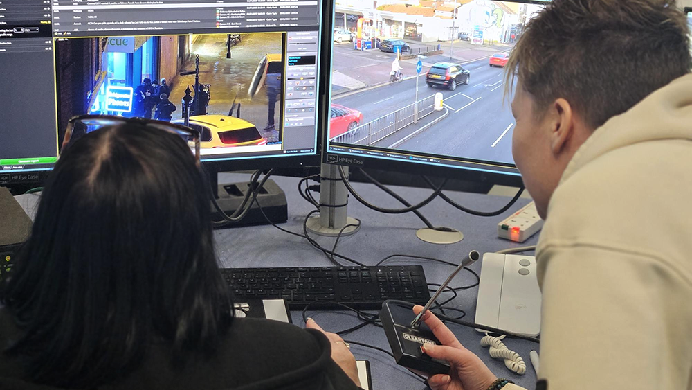 Two CCTV operators monitor live footage on dual screens to help capture and report incidents to Somerset police.