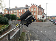 Damaged traffic signal leaning over railings at a busy street junction in Somerset scheduled for replacement in early 2026.