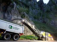 Road resurfacing machinery working at Cheddar Gorge with Heidelberg Materials truck during scheduled improvement works.