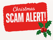 Red banner with white text reading “Christmas Scam Alert!” and green holly with red berries in the bottom right corner.