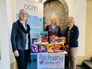 L-R: Cllr Heather Shearer, Cally Hargrave and Amanda Gunter with donated Christmas gifts on a Fostering in Somerset display table.
