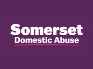 Somerset Domestic Abuse logo on a purple background, featuring the service name in white text with a pink underline.