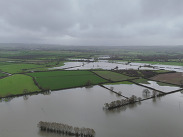 Aerial view of flooded Somerset Levels with submerged fields, illustrating the impact of flooding, by Somerset By Drone.