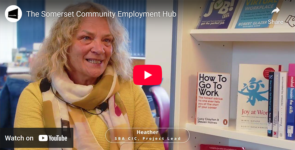 Somerset Film YouTube thumbnail for “The Somerset Community Employment Hub” showing a person seated beside books including How To Go To Work.