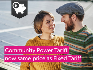 Two people standing beside solar panels with text reading “Community Power Tariff now same price as Fixed Tariff” and a savings icon.
