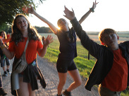 Young people taking part in a Mendip Hills National Landscape Young Rangers activity, walking along a rural path with countryside views.