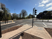 Traffic lights at Dunster junction, showing newly installed signals, road markings and pavements under clear skies.