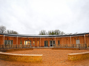 Ham Hill visitor centre building with timber cladding and curved design, developed as part of the National Lottery Heritage Fund project.