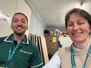 Alison Bell at her health check, smiling alongside an NHS health check professional inside a clinic setting.